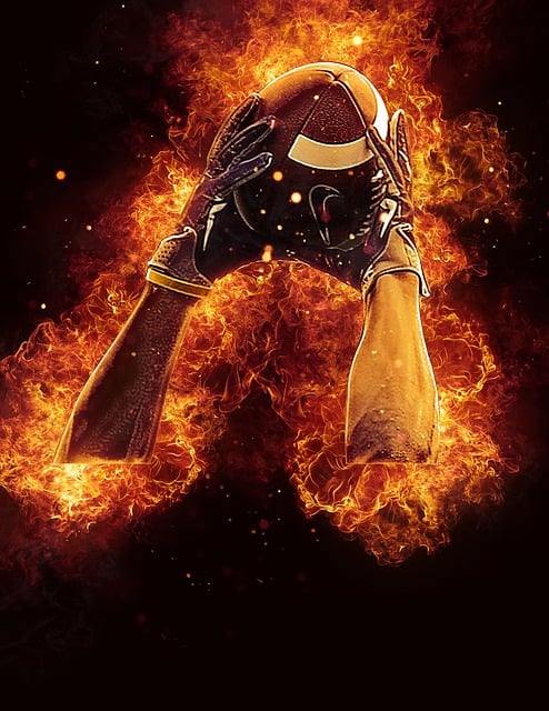 a black and white arms with a football in them and football gloves on their hands catching a football with fire along them and a space background