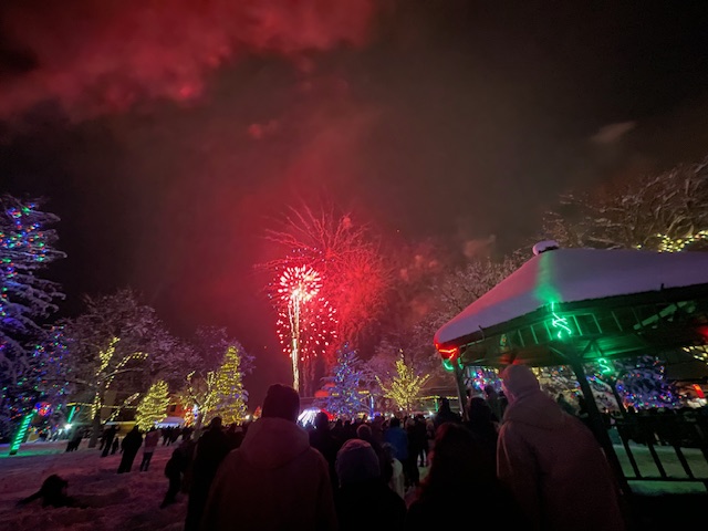 fireworks going off during a festival like event.