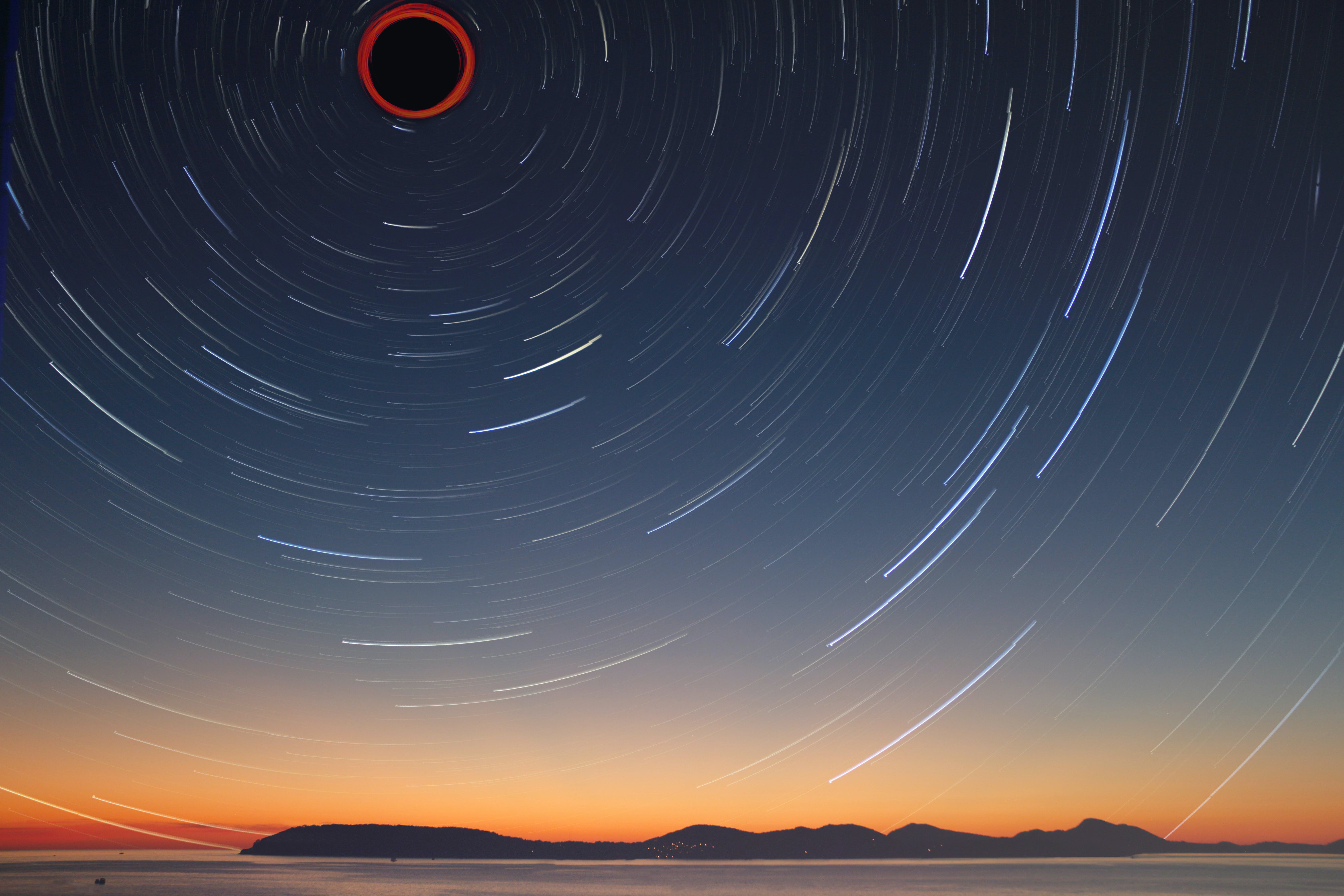 A circle of stars that center into a black hole.